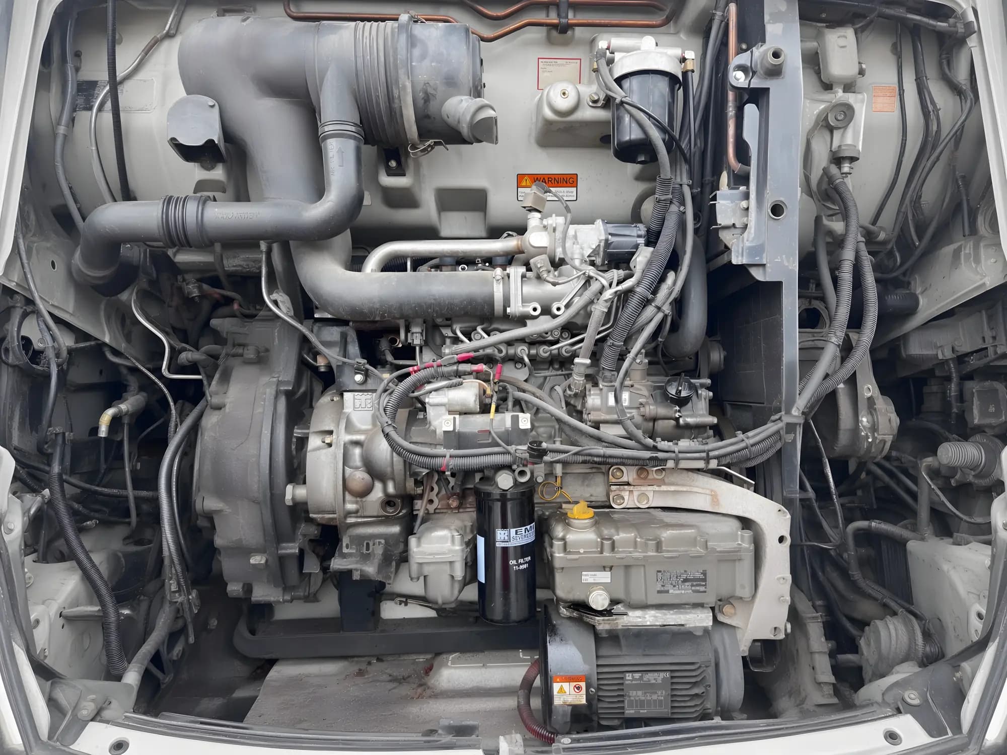 Clean diesel engine bay with charge piping and wiring visible.