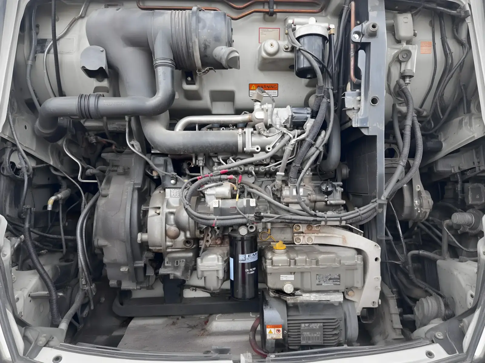 Clean diesel engine bay with charge piping and wiring visible.